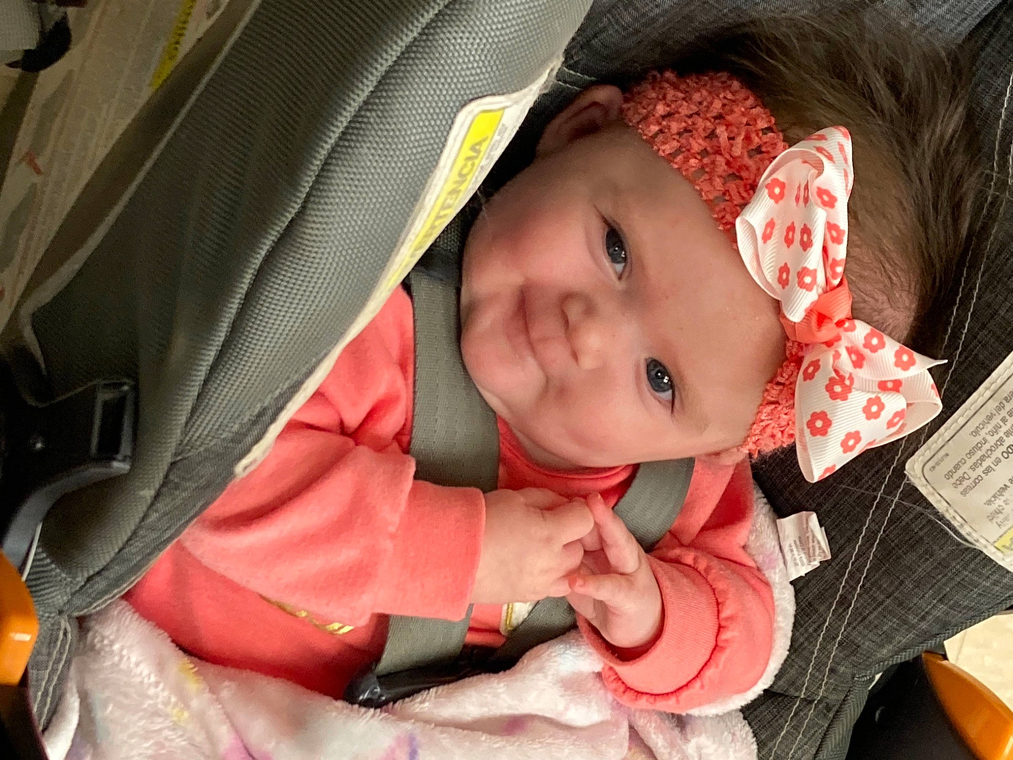 Kamila is registered to the contest to win money with this photo: baby, baby_carriage, cheek, eye, eyelash, face, facial_expression, happy, headgear, headwear, iris, lip, mouth, nose, outerwear, person, pink, product, skin, smile