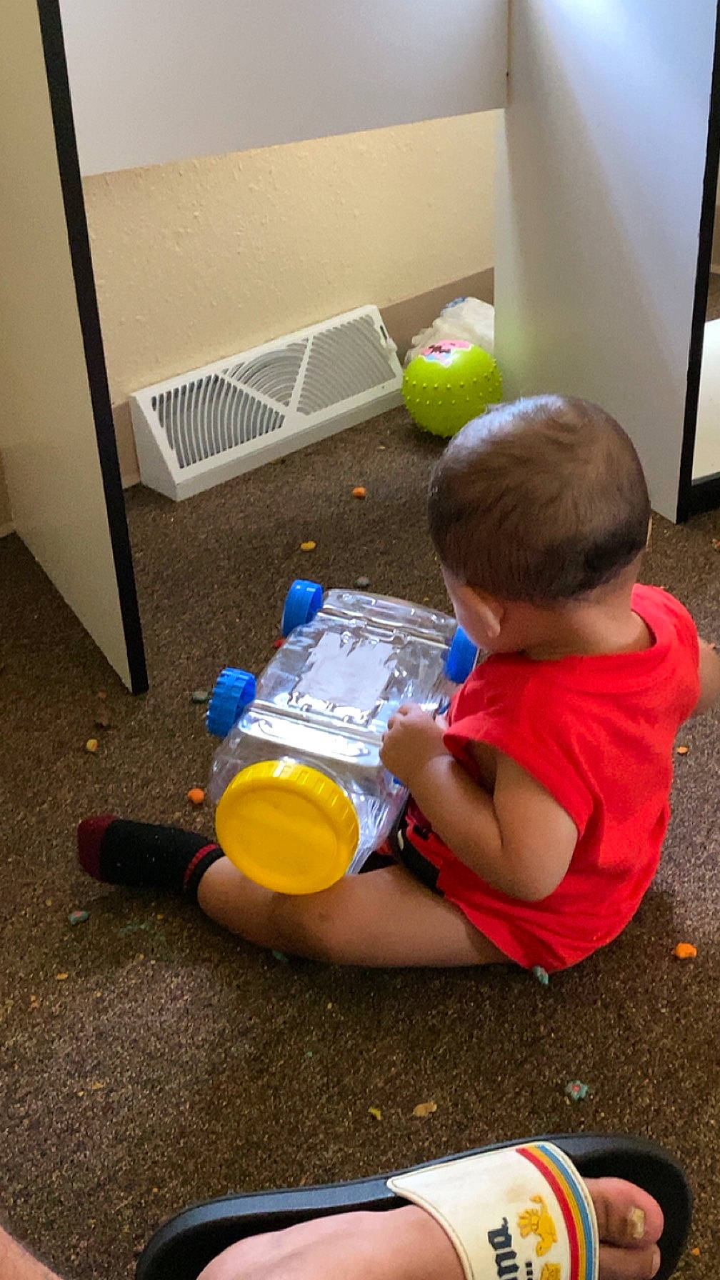 Evelyn is registered to the contest to win money with this photo: baby, baby_products, baby_toys, carmine, child, floor, flooring, fun, human_leg, person, play, room, sitting, toddler, toy