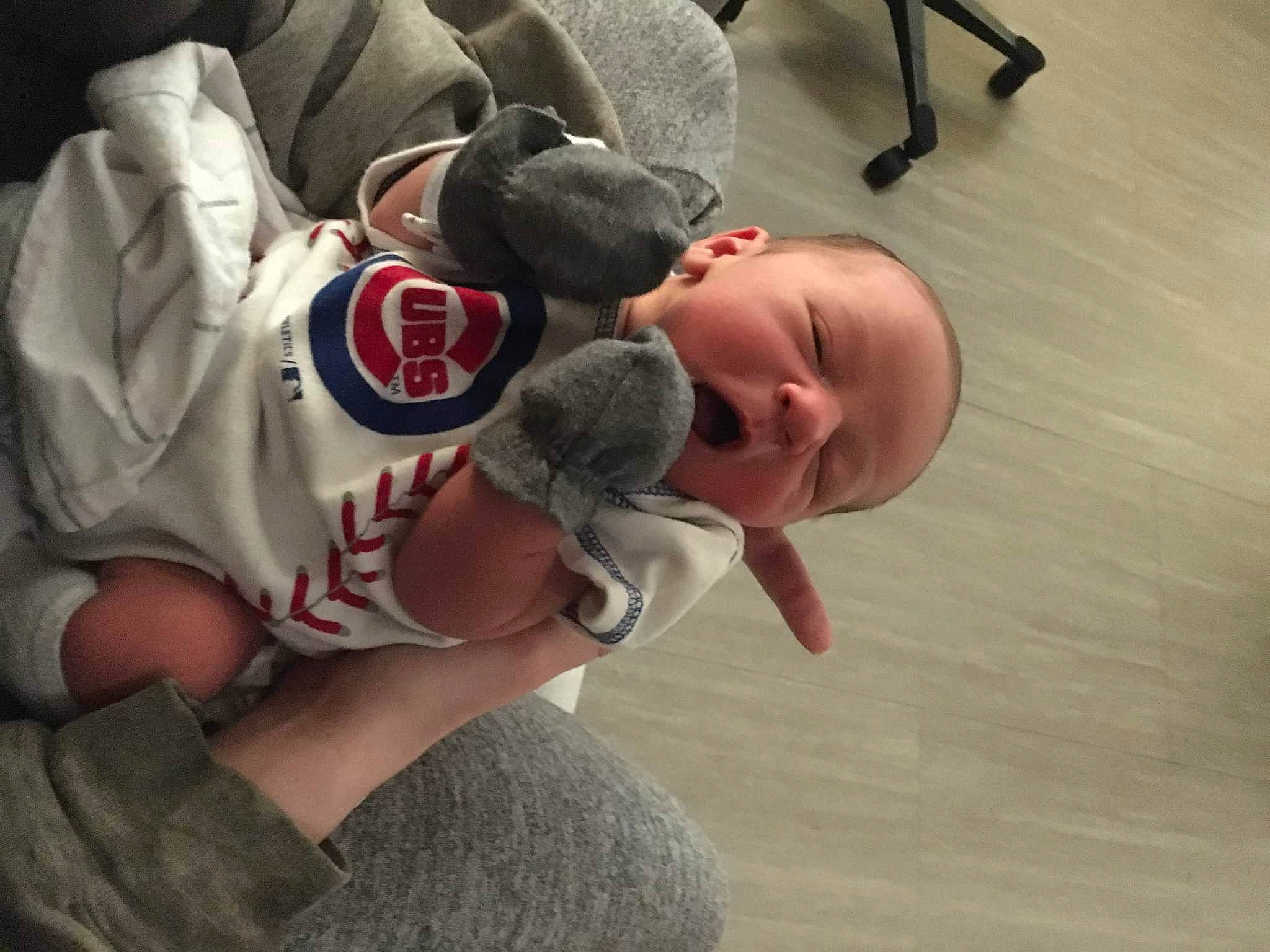 Trevor joined the competition — help win amazing prizes! baby, baby_toddler_clothing, baseball_cap, cap, carmine, child, comfort, elbow, finger, flooring, fun, gesture, happy, joint, mouth, person, sitting, t_shirt, thumb, toddler