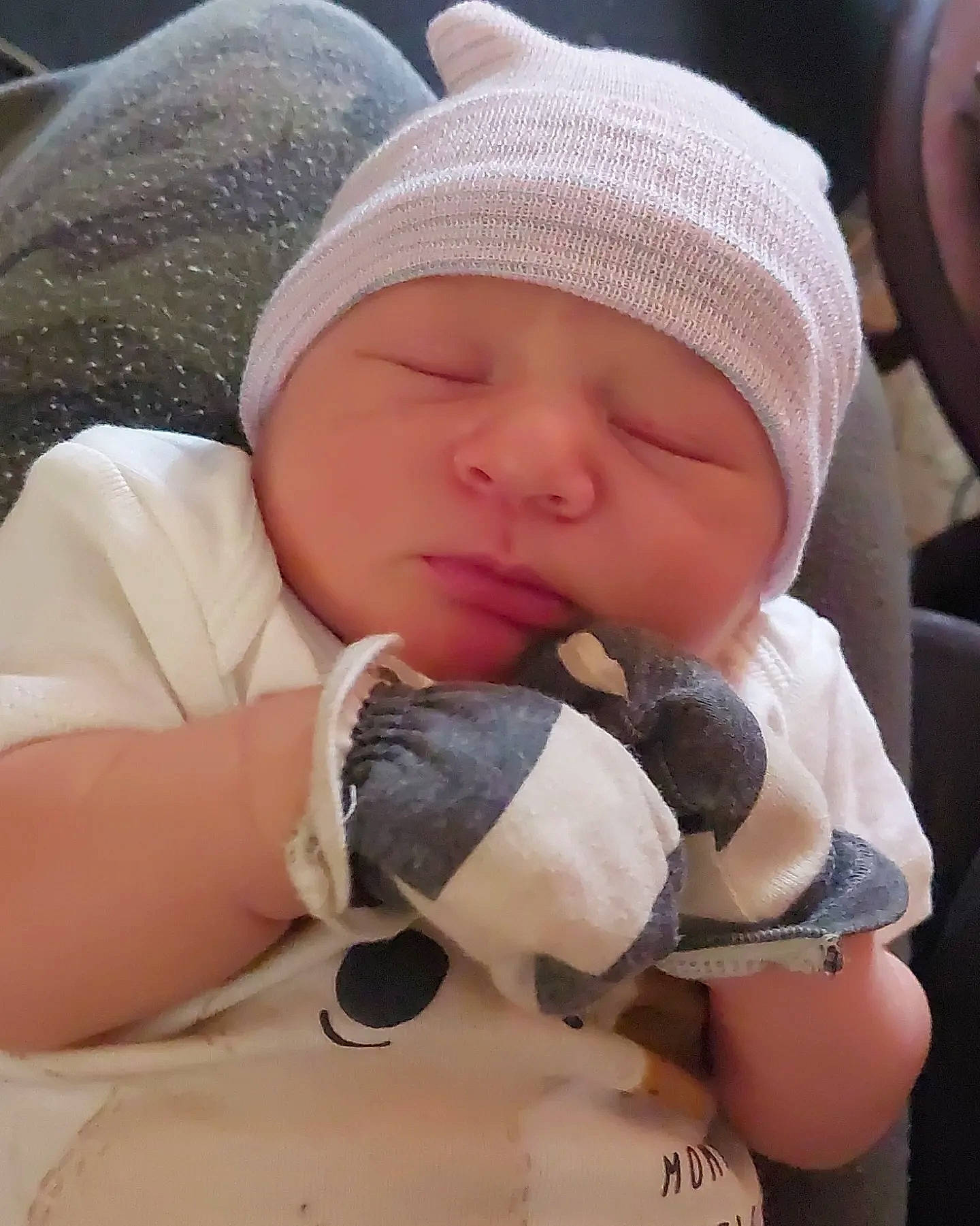 Trevor joined the competition — help win amazing prizes! baby, baby_sleeping, baby_toddler_clothing, cap, comfort, eye, finger, hand, headwear, helmet, human_body, knit_cap, lip, nail, nose, person, skin, teddy_bear, textile, thumb