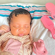Nalani is registered to the contest to win money with this photo: infant, baby, sleeping, blanket, pacifier, comb, pink, bedspread, striped, cozy, soft, cute, peaceful, child, newborn, resting, indoors, clothing, hand, face