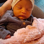 Oaklee joined the competition — help win amazing prizes! baby, newborn, sleeping, headwrap, flower, blanket, pink, purple, button, hand, cozy, soft, indoor, couch, child, infant, portrait, cute, resting, peaceful