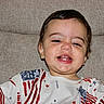 toddler, child, smiling, happy, face, portrait, american_flag, shirt, clothing, indoors, couch, furniture, young_child, cute, baby, person, seated, expression, head, skin