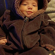 Kahleal joined the competition — help win amazing prizes! baby, child, infant, fuzzy_clothing, brown, hood, bear_ears, zipper, smile, face, hand, sitting, blanket, leather, couch, warm_clothing, cute, indoors, portrait, comfort
