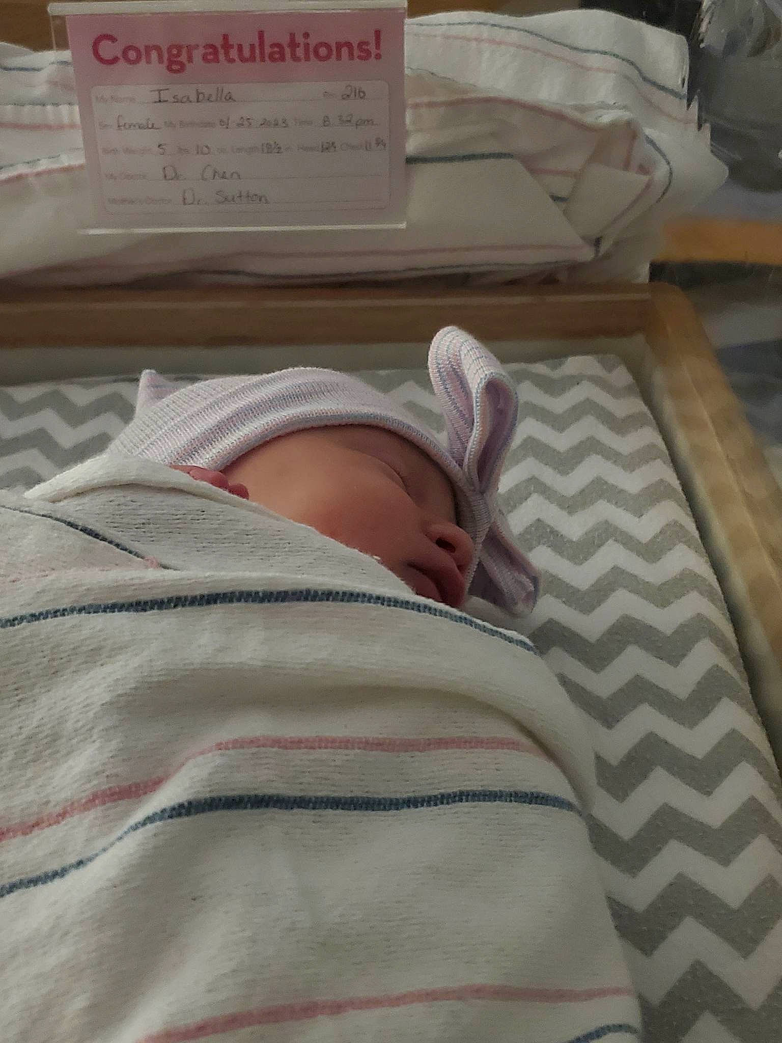 Isabella joined the competition — help win amazing prizes! baby, bed, bed_sheet, bedding, bedroom, blanket, comfort, font, handwriting, hat, hospital, linens, medical, nap, pattern, person, room, sleeve, t_shirt, textile