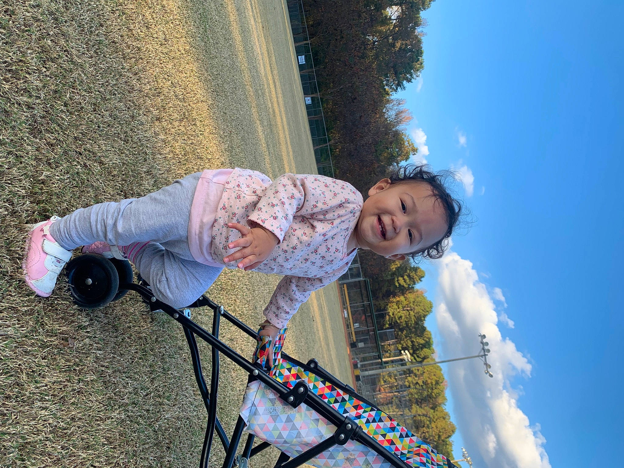 Delaney is registered to the contest to win money with this photo: child, cloud, electric_blue, fun, grass, happy, joy, leisure, lens_flare, people_in_nature, person, recreation, sitting, sky, smile, toddler, tree, vacation, winter