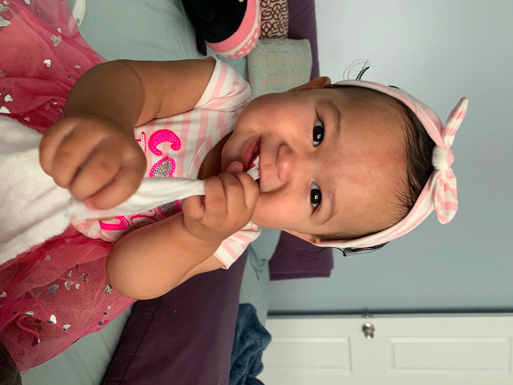 Delaney joined the competition — help win amazing prizes! baby_toddler_clothing, cheek, dress, ear, eye, eyelash, face, facial_expression, finger, gesture, happy, head, lip, mouth, neck, nose, person, pink, skin, smile