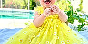 Aspen is registered to the contest to win money with this photo: baby, blanket, cheerful, child, cute, daisies, dress, greenery, happy, infant, nature, outdoor, person, pool, portrait, sitting, smiling, summer, sunlight, yellow_dress
