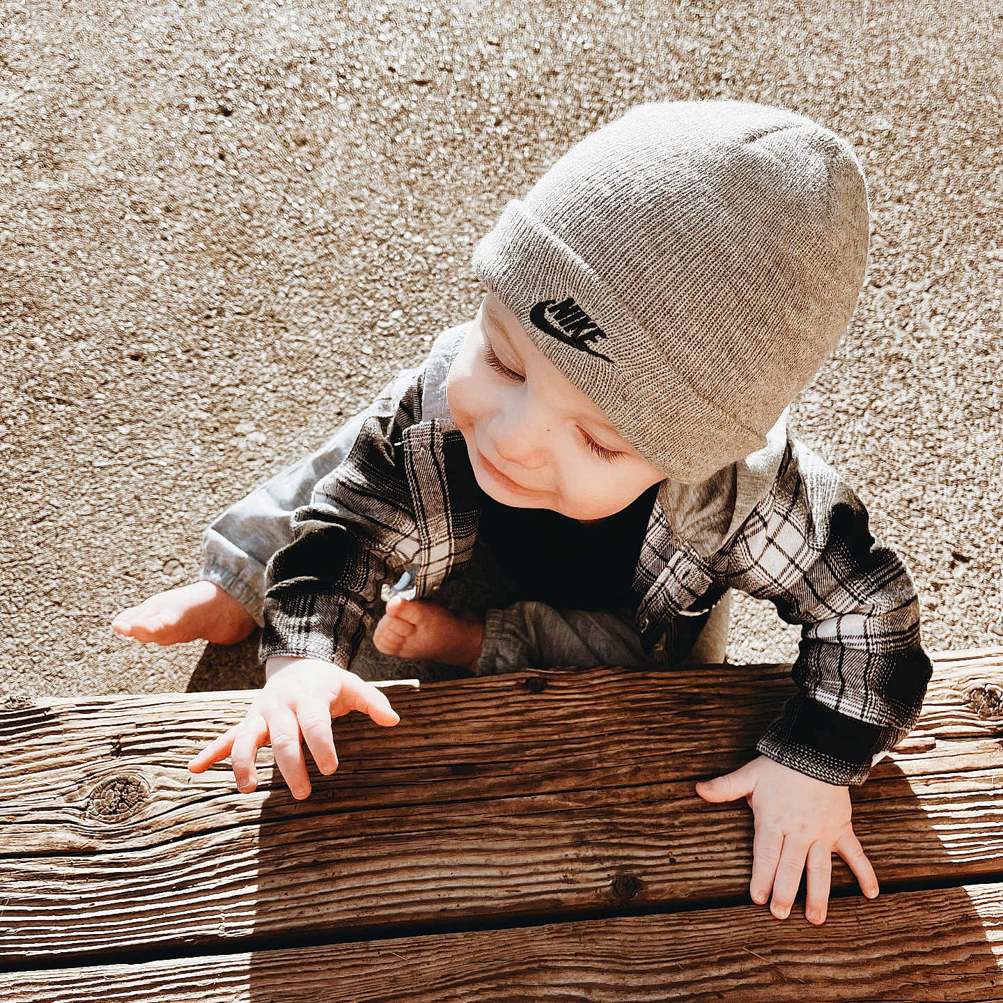 Layne is registered to the contest to win money with this photo: baby, babycrawling, beanie, bodypart, bonnet, cap, clothing, crawling, face, finger, hand, hardwood, hat, head, pants, person, photography, portrait, sitting, wood