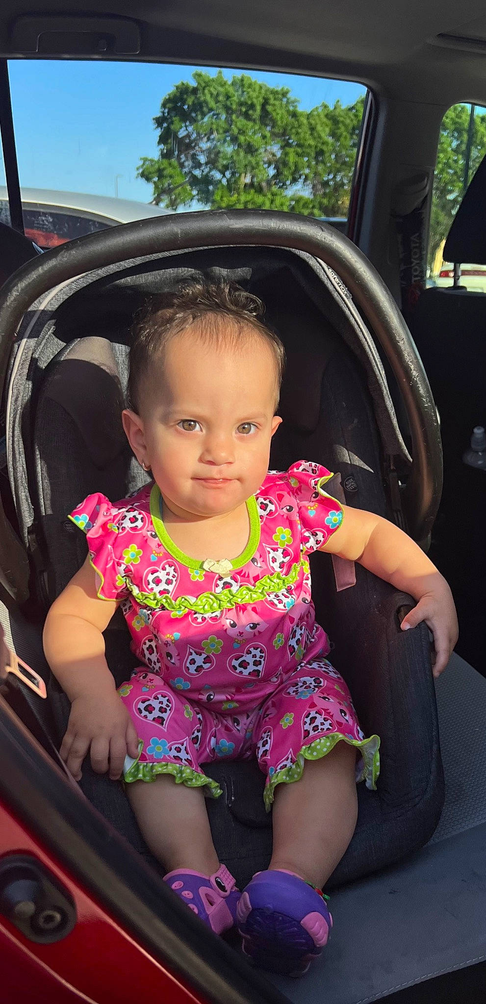 Amaya is registered to the contest to win money with this photo: auto_part, automotive_exterior, baby_toddler_clothing, black, car_seat, dress, finger, fun, happy, lip, magenta, motor_vehicle, person, pink, skin, sky, steering_wheel, thigh, toddler, vehicle_door