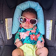 Octavia joined the competition — help win amazing prizes! baby, child, car_seat, sunglasses, colorful_clothing, floral_pattern, infant, seat_belt, head_support, cute, small_hands, legs, bright_colors, accessory, fashion, toddler, babywear, comfort, relaxed, indoor