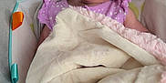 Octavia is registered to the contest to win money with this photo: baby, baby_seat, blanket, child, closeup, comfort, cozy, cushion, cute, face, happy, indoors, infant, polka_dots, portrait, purple_clothing, resting, smile, soft, young_child
