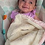 Octavia is registered to the contest to win money with this photo: baby, infant, blanket, smile, face, purple_clothing, baby_seat, cushion, polka_dots, soft, cozy, indoors, child, young_child, cute, happy, portrait, resting, comfort, closeup
