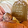 baby, newborn, sleeping, infant, portrait, headband, bow, blanket, pink, cream, cozy, bed, nursery, prayer_sign, wooden_sign, indoor, peaceful, resting, closed_eyes, soft_textures