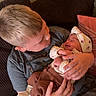 Kaizley is registered to the contest to win money with this photo: child, newborn, baby, brother, infant, cuddling, 抱抱, sleeping, family, portrait, indoors, couch, blanket, hat, clothing, hands, smiling, tender, home, photography