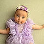 Mané participe au concours pour gagner de l'argent avec cette photo : baby, infant, child, purple_dress, ruffles, headband, flower, cute, portrait, soft_lighting, lying_down, innocent, rosy_cheeks, closeup, smile, hands, delicate, fabric, texture, soft_background