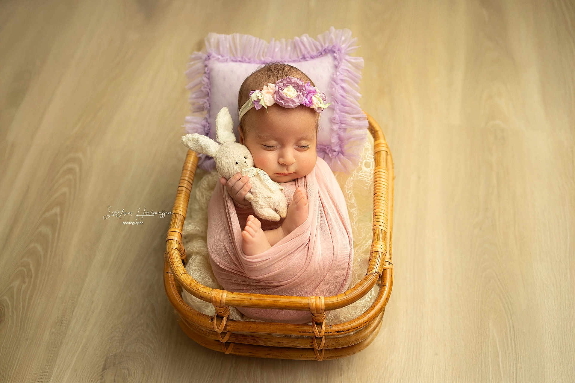 Mané participe au concours pour gagner de l'argent avec cette photo : baby, sleeping, wrapped, blanket, bunny_toy, wicker_basket, pillow, lavender, headband, flooring, cute, infant, peaceful, indoors, soft_lighting, portrait, newborn, cozy, child, resting
