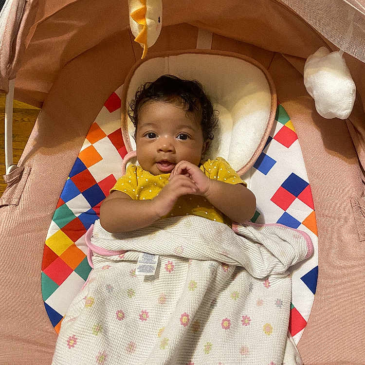 Kaylani joined the competition — help win amazing prizes! baby, bed, blanket, bodypart, cradle, crib, cushion, face, finger, furniture, hand, happy, head, homedecor, infantbed, person, photography, portrait, quilt, smile