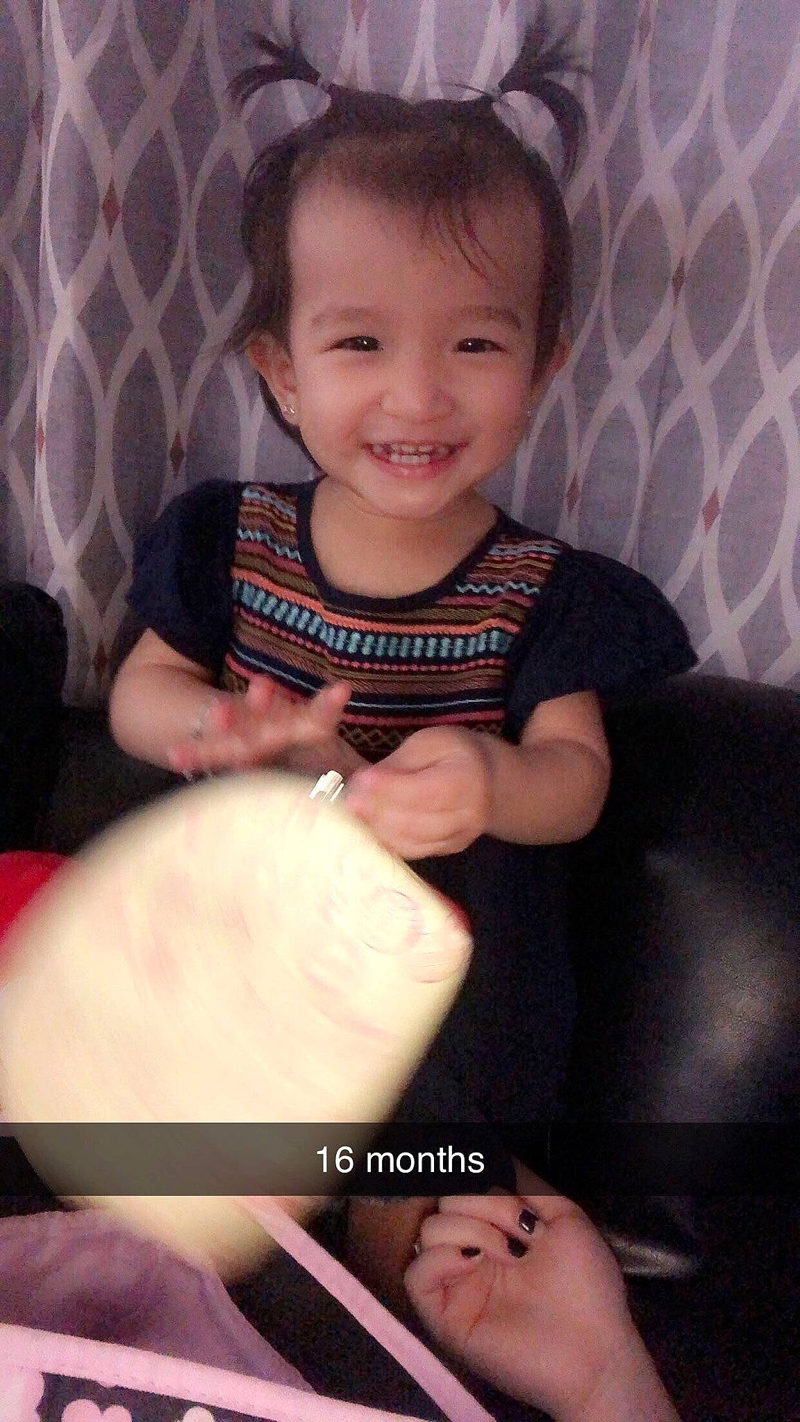 Delilah is registered to the contest to win money with this photo: baby, cheek, child, daughter, face, finger, head, joy, lip, nose, person, sitting, skin, smile, thumb, toddler