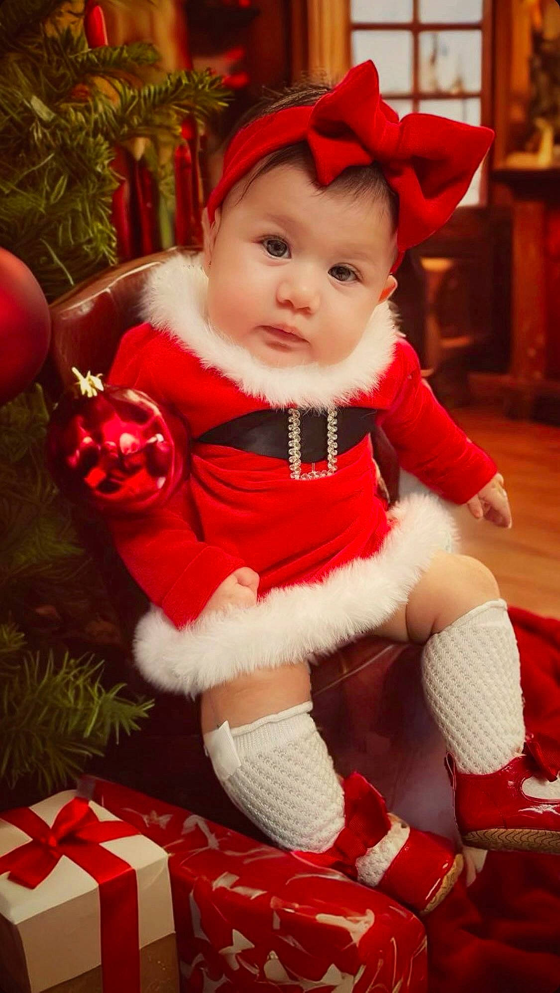 Valentina joined the competition — help win amazing prizes! baby, baby_toddler_clothing, cabinetry, christmas, christmas_decoration, christmas_ornament, christmas_tree, costume_hat, event, fictional_character, happy, hat, holiday, human_body, lap, ornament, person, red, santa_claus, toddler