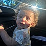 Willow joined the competition — help win amazing prizes! child, toddler, curly_hair, smiling, sunlight, inside_car, window, white_shirt, short_sleeves, reaching, face, eyes, cute, portrait, young_child, daylight, seat, car_interior, happy, skin