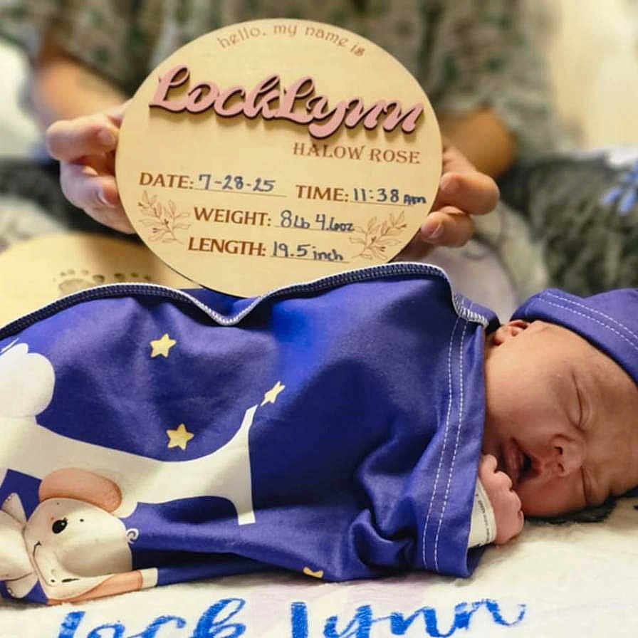 Locklynn is registered to the contest to win money with this photo: baby, birth_details, blanket, blue, cute, hat, indoor, infant, newborn, peaceful, person, plush_surface, portrait, resting, sign, sleeping, soft_toys, stars, wooden_sign, wrapped