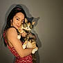Mitsy joined the competition — help win amazing prizes! woman, cat, calico_cat, pet, holding, red_dress, floral_pattern, portrait, indoor, shadow, long_hair, smile, animal, cute, looking_at_camera, love, affection, friendly, human, warm_lighting