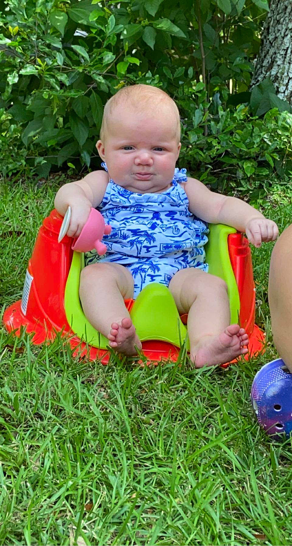 Blakely is registered to the contest to win money with this photo: baby, baby_toddler_clothing, child, facial_expression, finger, fun, grass, grass_family, happy, lawn, leg, leisure, mammal, meadow, people_in_nature, person, plant, play, shorts, sitting