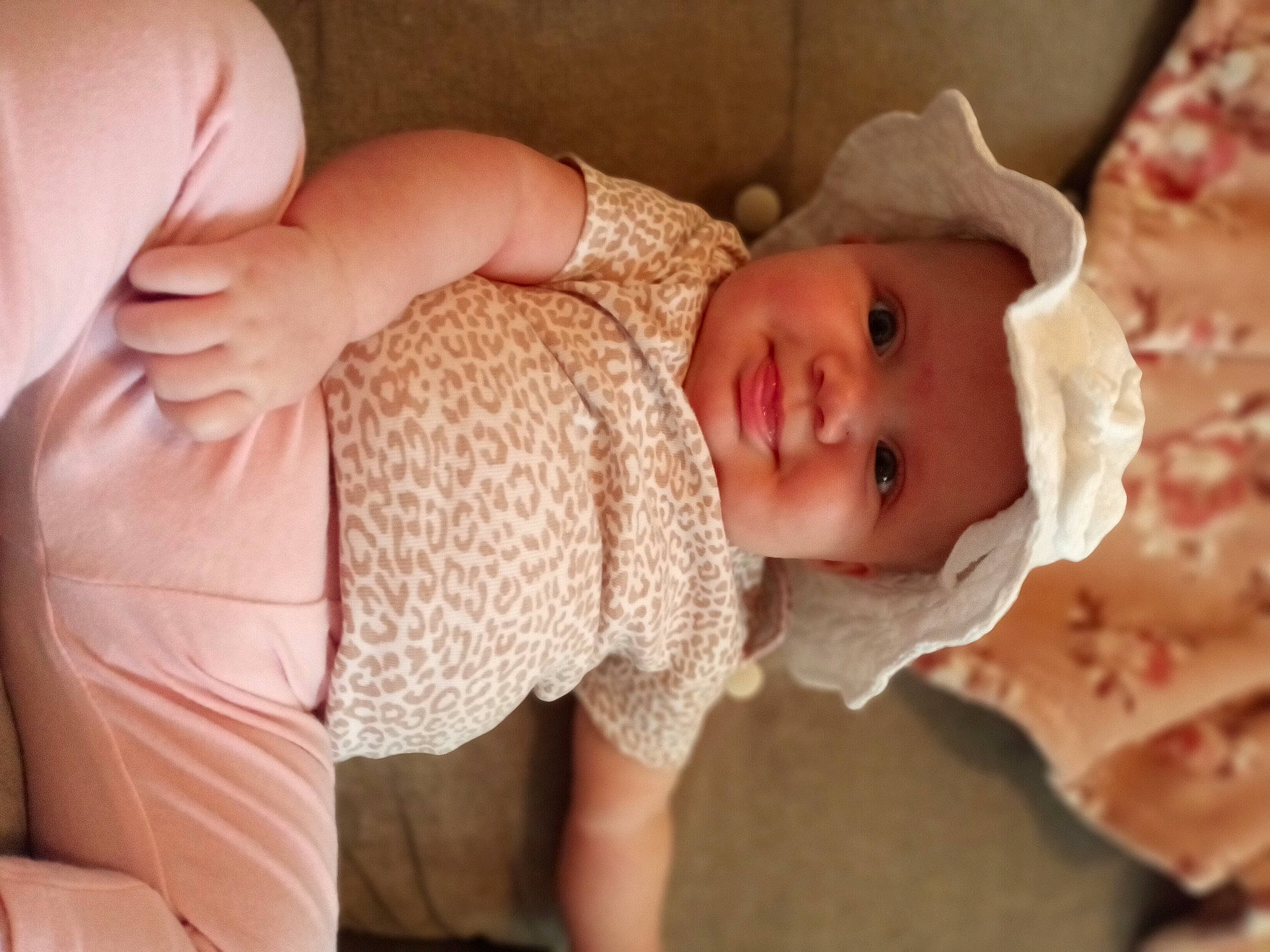 Blakely is registered to the contest to win money with this photo: arm, baby, baby_toddler_clothing, cheek, comfort, dress, finger, gesture, hand, headwear, human_body, iris, joint, lip, muscle, neck, person, pink, skin, sleeve