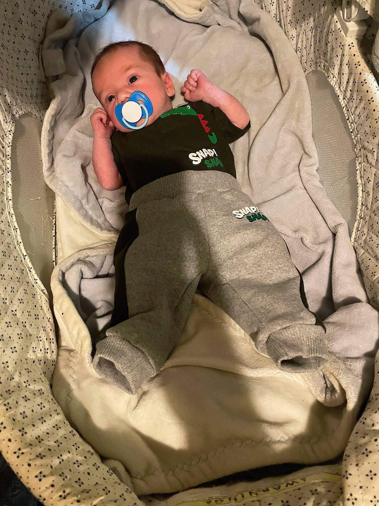 Chase is registered to the contest to win money with this photo: baby, baby_carriage, baby_products, baby_safety, baby_sleeping, baby_toddler_clothing, carmine, child, comfort, human_leg, knee, lap, linens, pattern, person, personal_protective_equipment, sitting, sleeve, sock, thigh