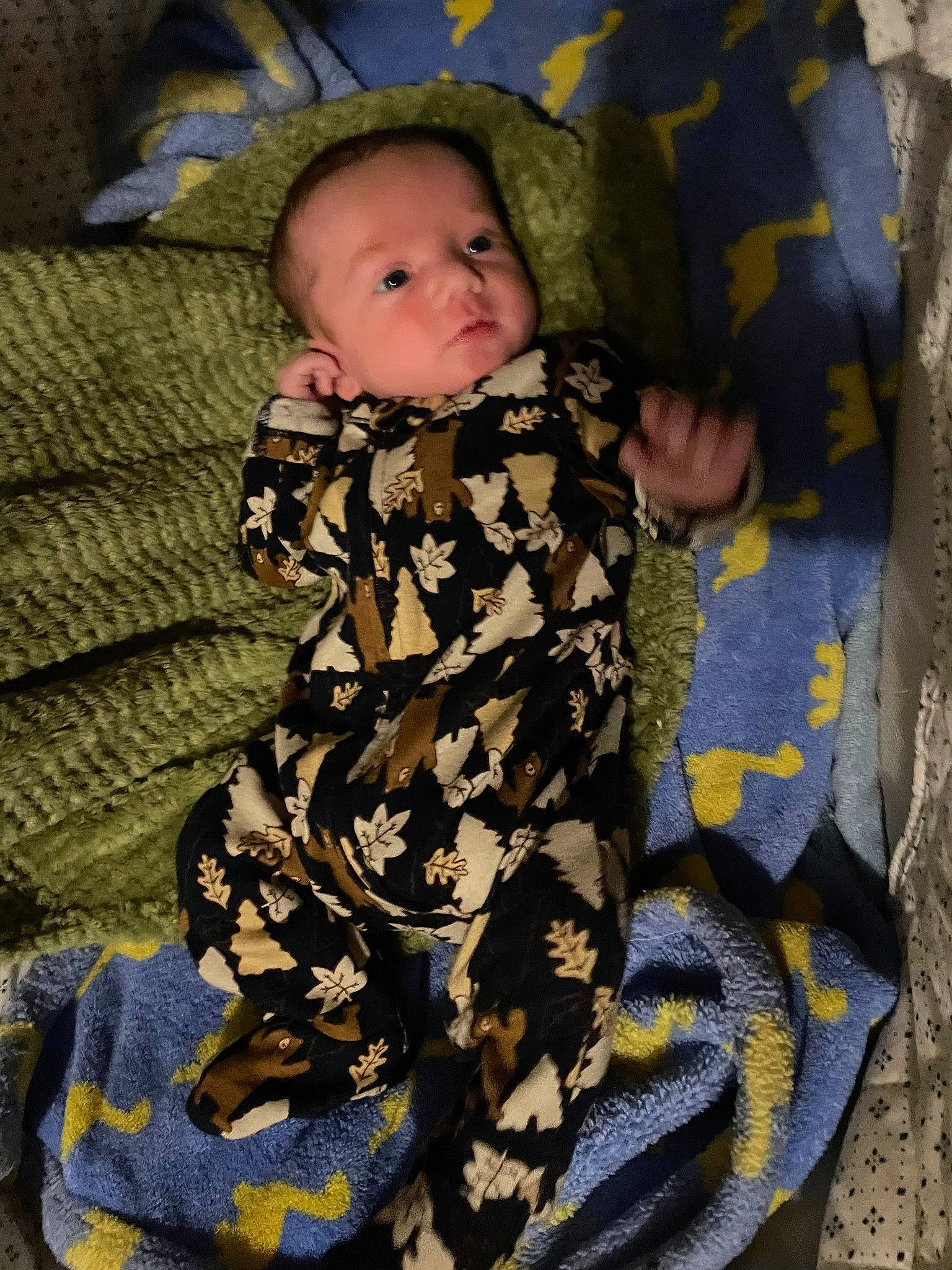 Chase is registered to the contest to win money with this photo: baby, baby_toddler_clothing, camouflage, child, comfort, human_leg, linens, military_camouflage, military_uniform, pattern, person, sitting, sleeve, textile, thigh, toddler, wood