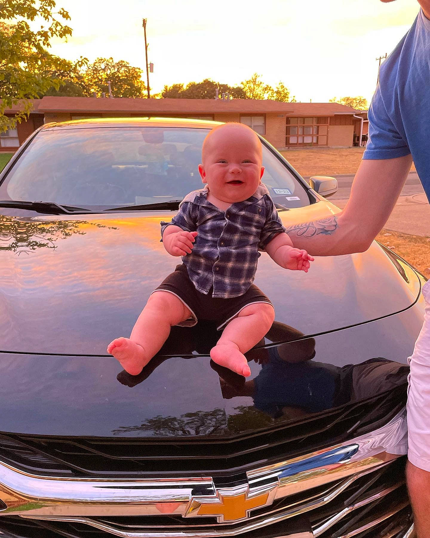 Brixton is registered to the contest to win money with this photo: automotive_design, automotive_exterior, automotive_lighting, automotive_tire, bumper, car, clothing, grille, headlamp, hood, land_vehicle, light, motor_vehicle, person, shorts, tire, tree, vehicle, vehicle_door, wheel