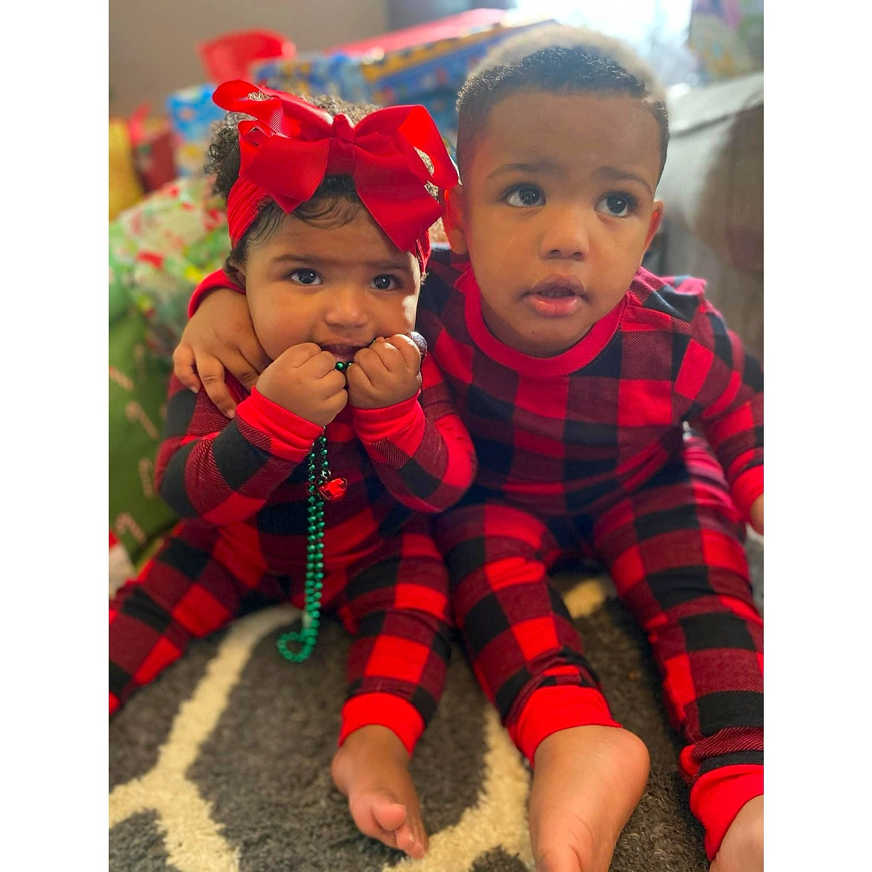 Jonathan is registered to the contest to win money with this photo: baby, baby_toddler_clothing, clothing, face, grass, happy, head, headwear, mammal, outerwear, pattern, people, person, plaid, product, red, skin, sleeve, tartan, textile