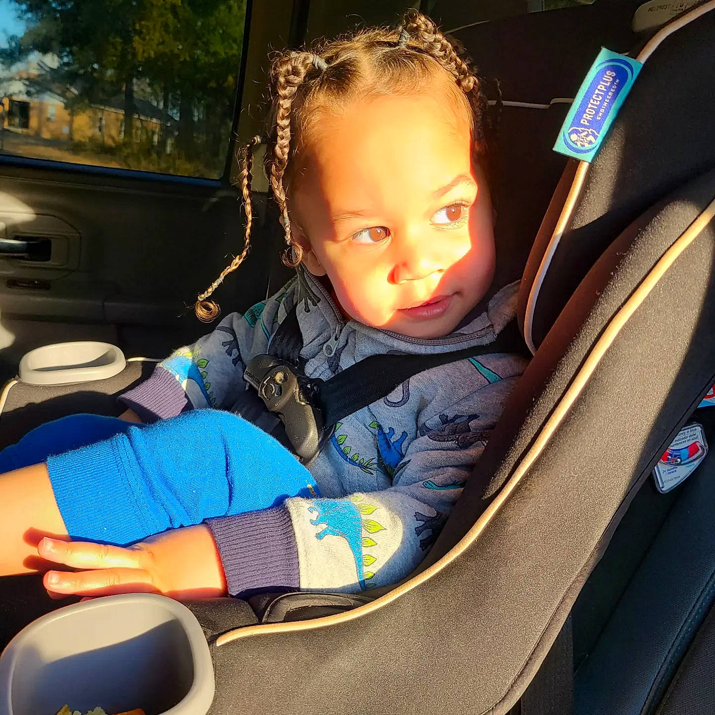 Keagan is registered to the contest to win money with this photo: auto_part, automotive_design, automotive_exterior, baby_products, car, car_seat, car_seat_cover, comfort, electric_blue, family_car, fun, head_restraint, leisure, motor_vehicle, person, sitting, tints_and_shades, toddler, tree, vehicle_door