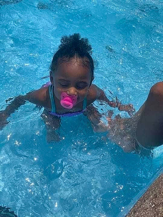 Treasure is registered to the contest to win money with this photo: azure, bathing, beauty, child, electric_blue, fun, happy, leisure, leisure_centre, outdoor_recreation, person, personal_protective_equipment, play, recreation, smile, swimmer, swimming_pool, toddler, vacation, water