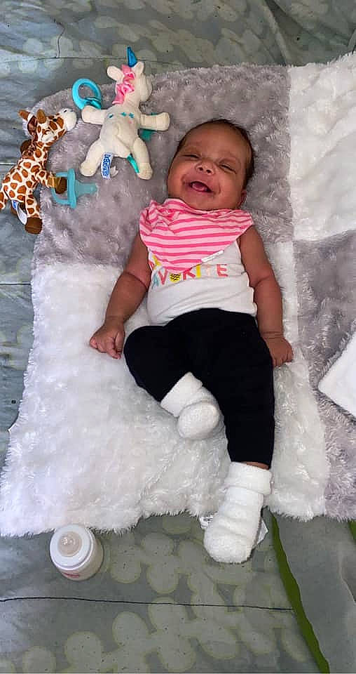 Anika joined the competition — help win amazing prizes! baby, baby_toddler_clothing, child, dress, event, fun, happy, head, mammal, organ, pattern, people, person, pink, sleeve, smile, sock, t_shirt, textile, toddler