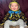 Joziah joined the competition — help win amazing prizes! baby, bonnet, cap, clothing, coat, costume, face, hat, head, hood, hoodie, jacket, knitwear, pants, person, photography, portrait, purple, sweater, sweatshirt