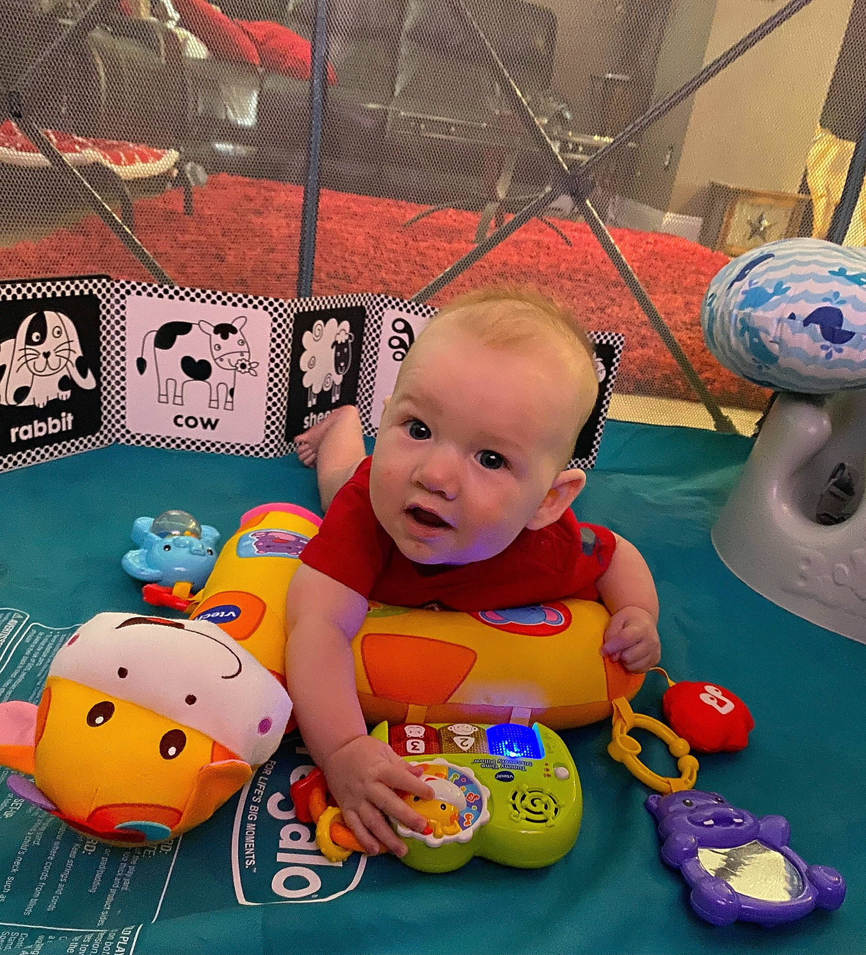 Tanner James joined the competition — help win amazing prizes! art, baby, baby_playing_with_toys, baby_products, baby_toddler_clothing, baby_toys, child, flooring, fun, happy, leisure, orange, person, play, product, recreation, room, sitting, smile, toddler