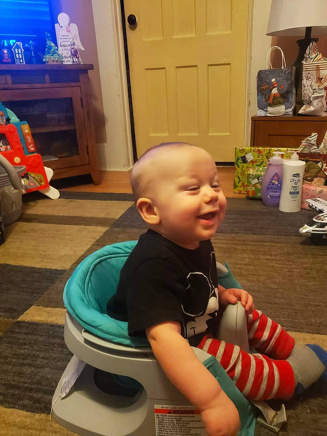 Atticus joined the competition — help win amazing prizes! baby, baby_toddler_clothing, blue, cabinetry, child, cupboard, door, floor, flooring, fun, hardwood, houseplant, person, photograph, play, sitting, smile, snapshot, standing, toddler