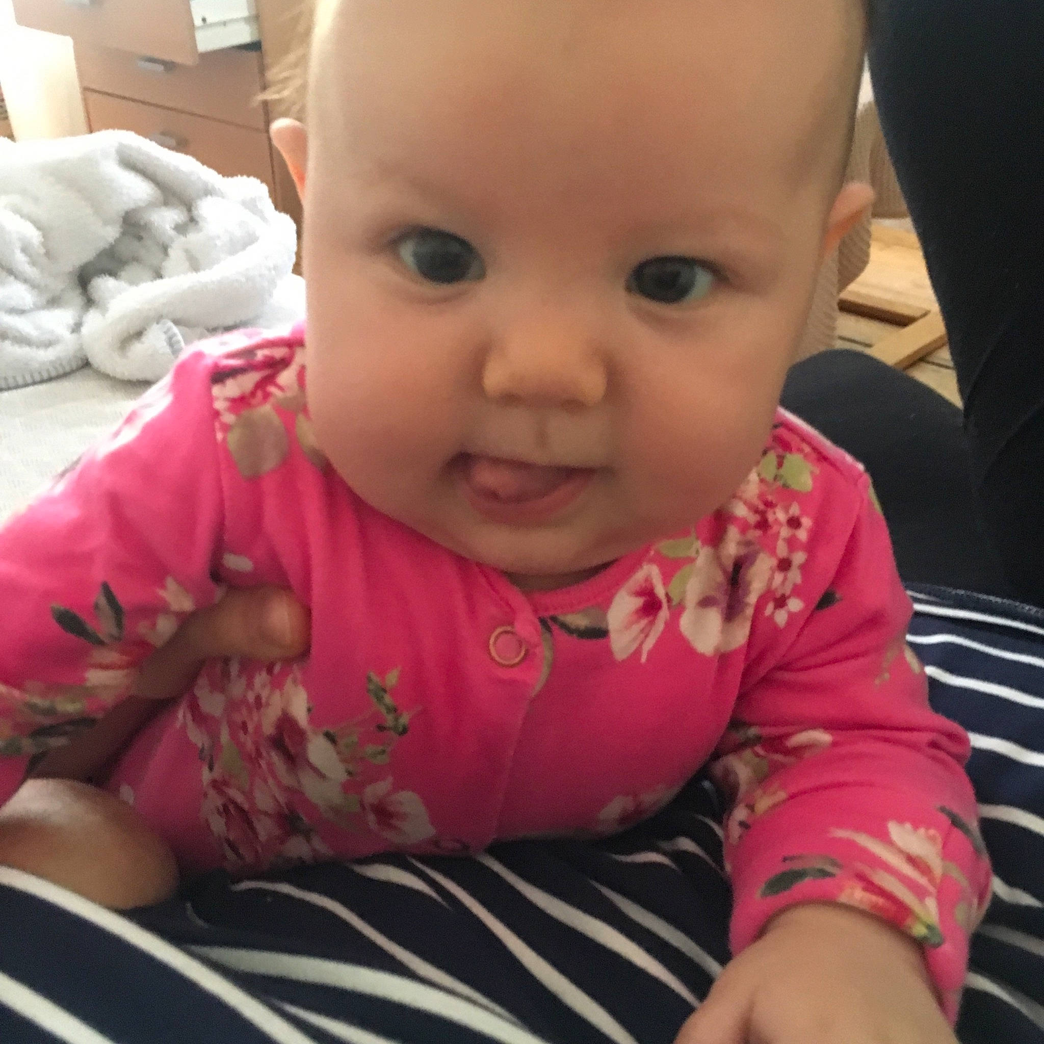 Silva joined the competition — help win amazing prizes! baby, beauty, cheek, child, electronic_device, eye, face, head, lip, mouth, nose, person, pink, sitting, skin, smile, toddler, tummy_time