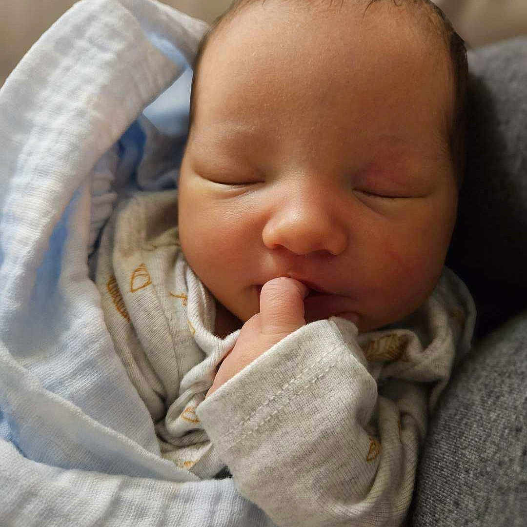 Odella joined the competition — help win amazing prizes! baby, blanket, face, happy, head, newborn, person, photography, portrait, quilt, sleeping, smile, yawning