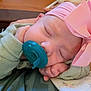 baby, sleeping, pacifier, pink_bow, headwear, infant, closeup, hand, soft_clothing, blanket, resting, peaceful, cute, portrait, child, indoors, cozy, newborn, face, sleep