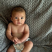 Emery Rose joined the competition — help win amazing prizes! baby, infant, child, diaper, couch, textured_fabric, sitting, curious, hands, feet, skin, indoors, portrait, young_child, expression, soft_light, comfort, cozy, home, casual
