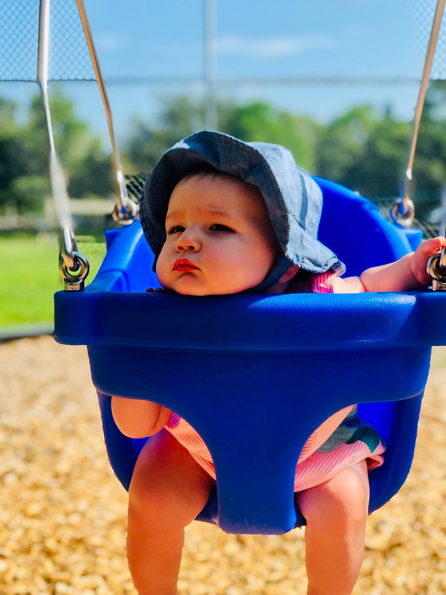 Parker is registered to the contest to win money with this photo: azure, baby, baby_toddler_clothing, blue, electric_blue, fun, happy, hat, leisure, outdoor_play_equipment, people_in_nature, people_on_beach, person, photograph, playground, public_space, recreation, sky, swing, toddler