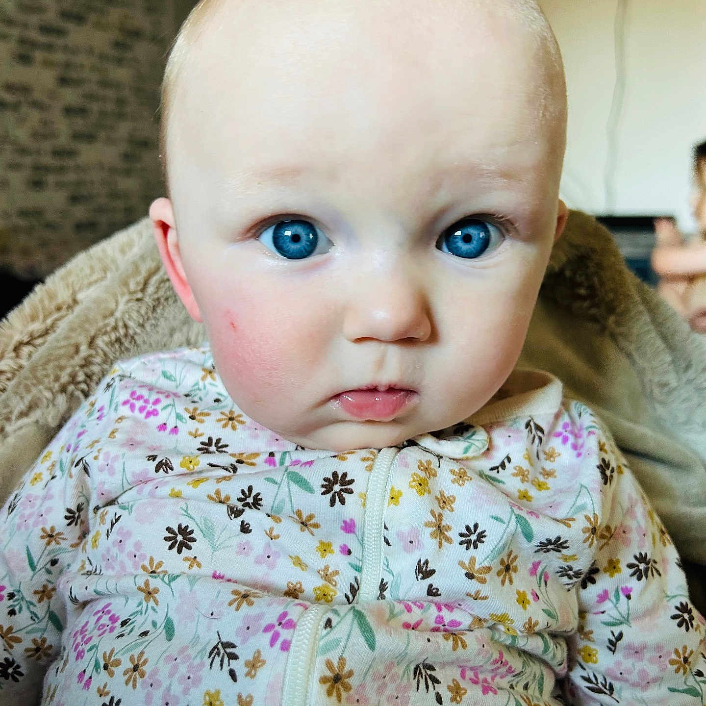 Eliana is registered to the contest to win money with this photo: baby, blonde, clothing, coat, face, frown, hair, happy, head, jacket, knitwear, newborn, person, photography, portrait, quilt, sad, selfie, smile, sweater