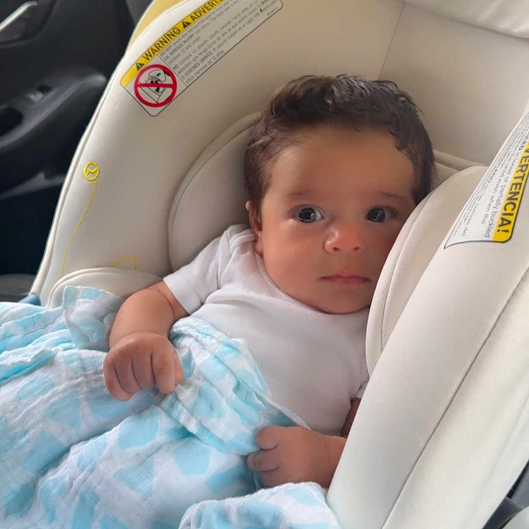 Nathan Pache joined the competition — help win amazing prizes! baby, blanket, blue_pattern, car_interior, car_seat, cute, eyes, face, hair, hand, headrest, infant, newborn, onesie, portrait, safety_label, seat, swaddle, travel, window