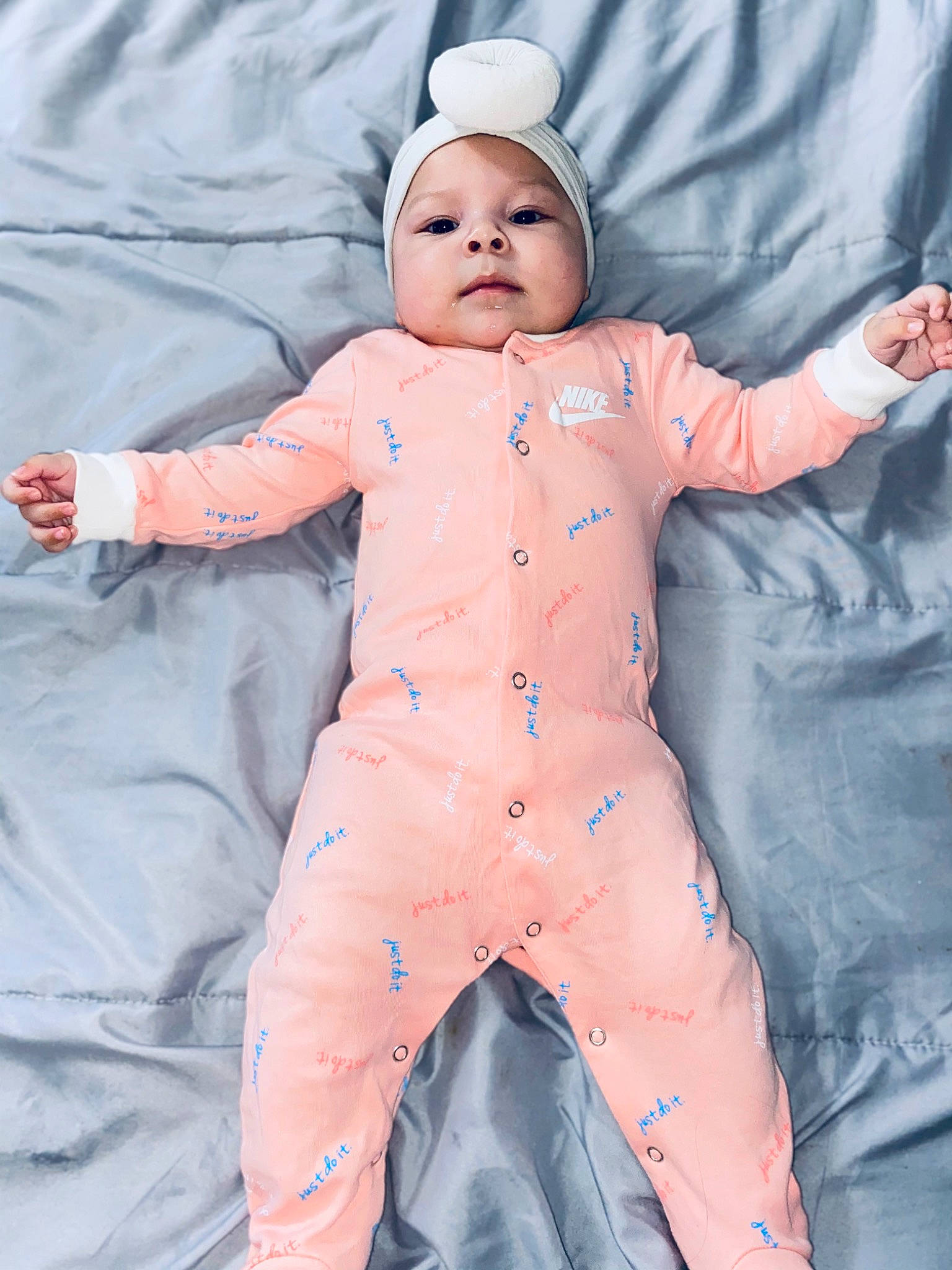 Mayra is registered to the contest to win money with this photo: abdomen, baby, baby_products, baby_toddler_clothing, cap, cheek, child, comfort, eye, facial_expression, gesture, hand, happy, hat, headwear, pattern, person, personal_protective_equipment, pink, skin