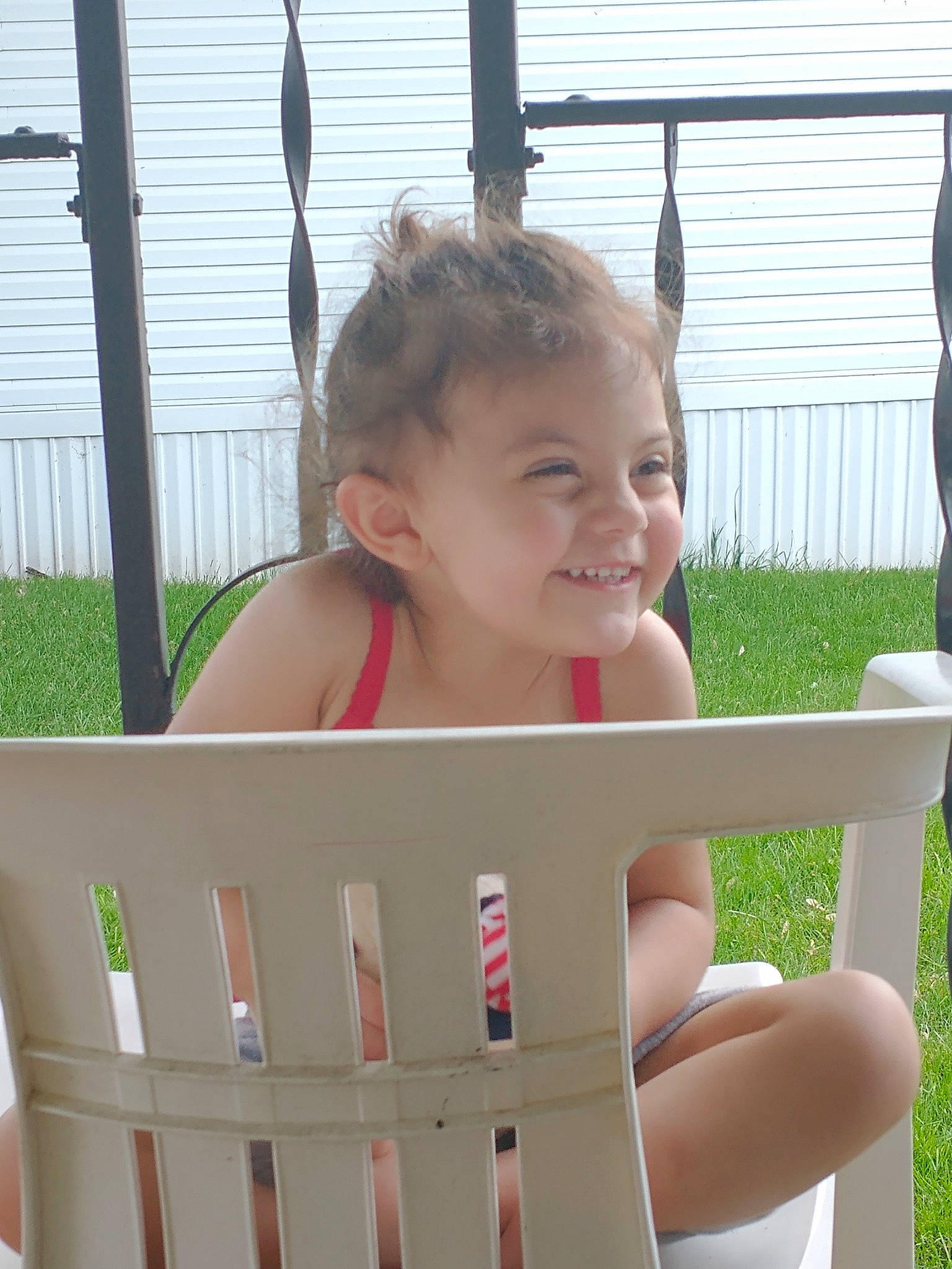 Autumn is registered to the contest to win money with this photo: baby, baby_products, baby_toddler_clothing, chair, child, fence, finger, fun, grass, happy, joy, leisure, outdoor_furniture, person, plant, sitting, skin, smile, thigh, thumb