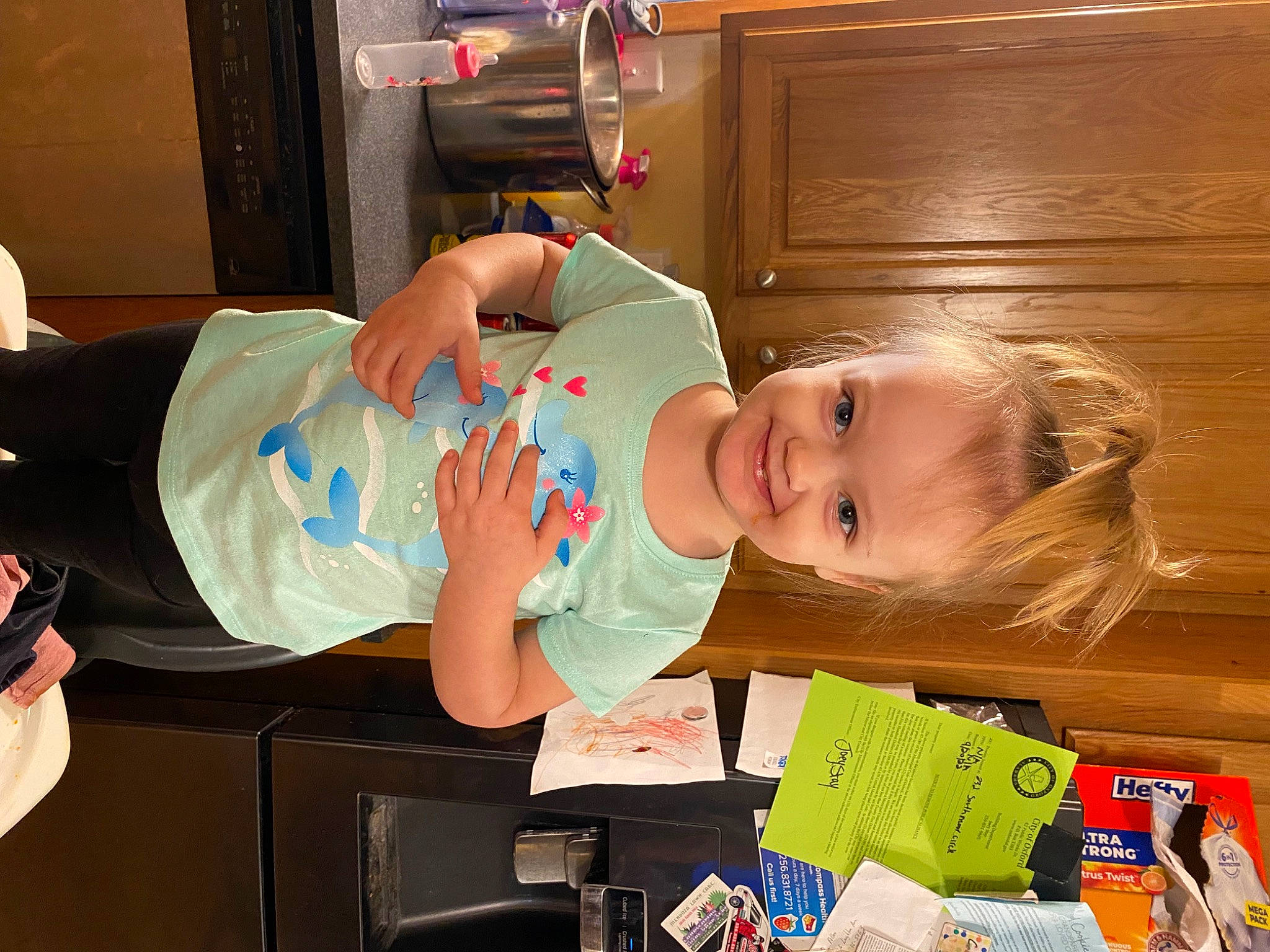 Bridget is registered to the contest to win money with this photo: baby, baby_products, baby_toddler_clothing, child, finger, fun, happy, hardwood, hat, joy, party, person, play, room, smile, t_shirt, toddler, varnish, wood