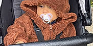 Saint Given joined the competition — help win amazing prizes! baby, baby_stroller, babywearing, bear_ears, blanket, child, clothing, cozy, cute, face, fuzzy, hoodie, infant, outdoor, pacifier, person, portrait, seatbelt, stroller, warm